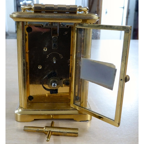 16 - A 20thC lacquered brass and glazed cased carriage timepiece; the movement faced by a Roman dial, ins... 