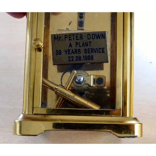 16 - A 20thC lacquered brass and glazed cased carriage timepiece; the movement faced by a Roman dial, ins... 