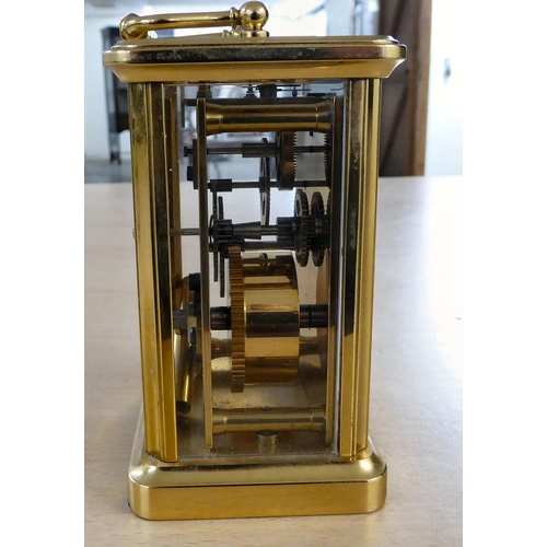 16 - A 20thC lacquered brass and glazed cased carriage timepiece; the movement faced by a Roman dial, ins... 