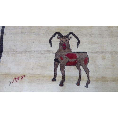 160 - A Persian Gabbeh design pictorial rug, depicting a ram and text  44