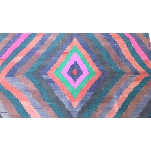 176 - A Kelim design rug, decorated with geometric patterns, on a multi-coloured ground  100