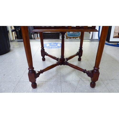 177 - An early/mid 20thC mahogany book table, the top over a rotating open, four division bookcase, raised... 