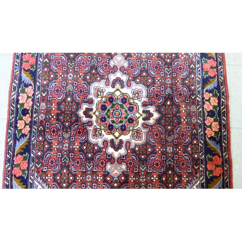 180 - A Persian design rug, decorated with a central medallion, surrounded by floral patterns  40