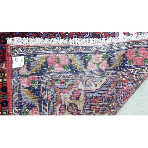 180 - A Persian design rug, decorated with a central medallion, surrounded by floral patterns  40