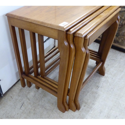 200 - A quartetto of modern teak occasional tables, raised on splayed legs  largest 21