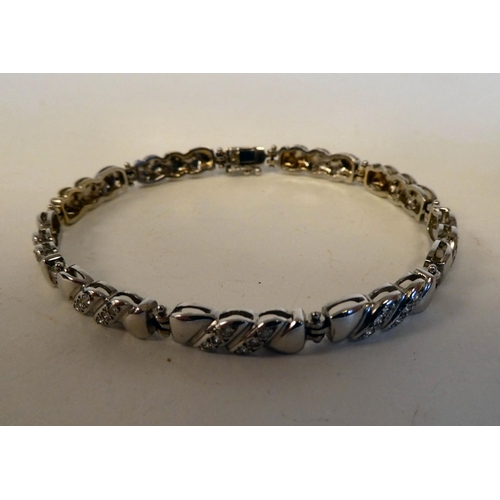 201 - An 18ct white gold, fancy link bracelet, set with diamonds; and an 18ct white gold ring, similarly s... 