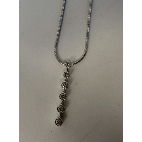 210 - An 18ct white gold necklet, set with a six stone diamond pendant, on a fine snake link chain and dog... 