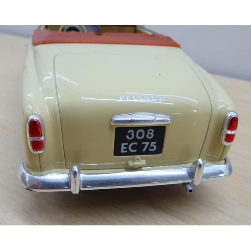 216 - Seven diecast and plastic model vehicles: to include a Solido 1/18 scale Peugeot 403 Cabriolet Grand... 