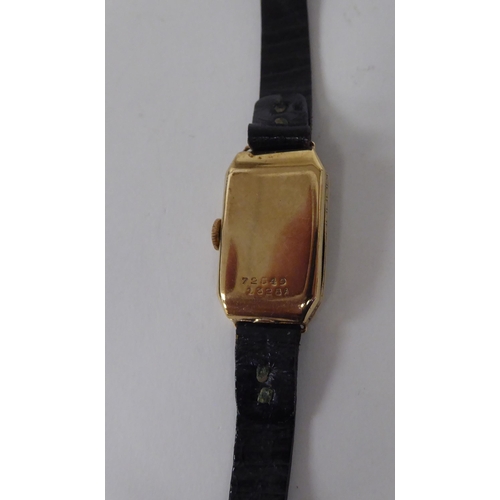 237 - A lady's Rolex 9ct gold cased wristwatch, faced by an engraved Arabic dial, on a black hide strap