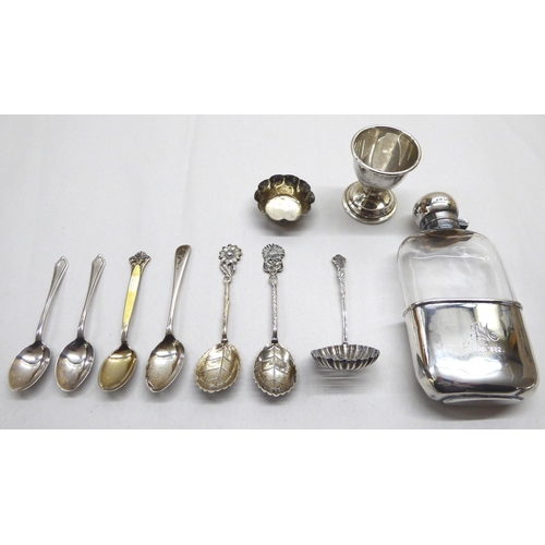 241 - Silver and white metal collectables: to include a late Victorian silver base and capped glass hip fl... 