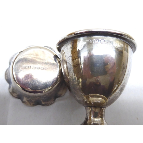 241 - Silver and white metal collectables: to include a late Victorian silver base and capped glass hip fl... 