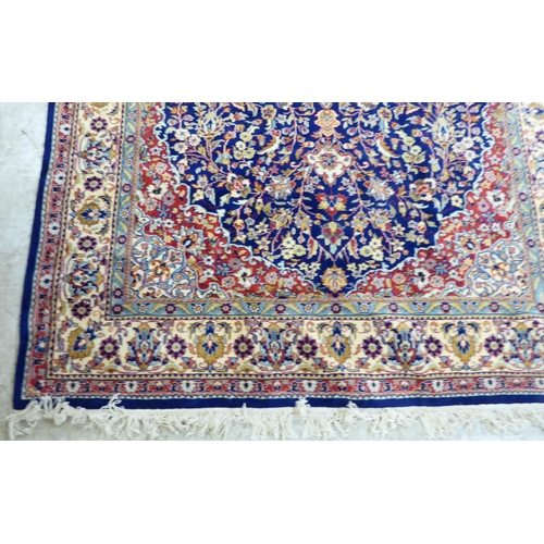 297 - A Persian rug, profusely decorated with floral designs, on a multi-coloured ground  74