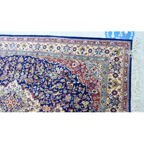 297 - A Persian rug, profusely decorated with floral designs, on a multi-coloured ground  74