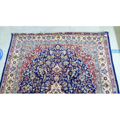 297 - A Persian rug, profusely decorated with floral designs, on a multi-coloured ground  74