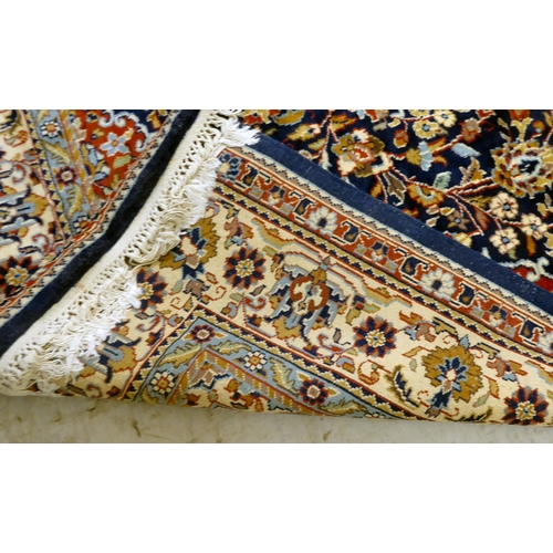 297 - A Persian rug, profusely decorated with floral designs, on a multi-coloured ground  74