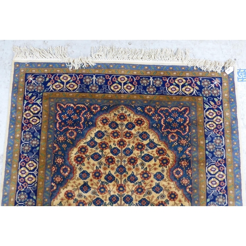 299 - A Prayer rug, decorated with flowerheads, on a multi-coloured ground  48