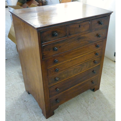 303 - A late 19thC mahogany secretaire chest with a facsimile fall front over five long drawers, raised on... 