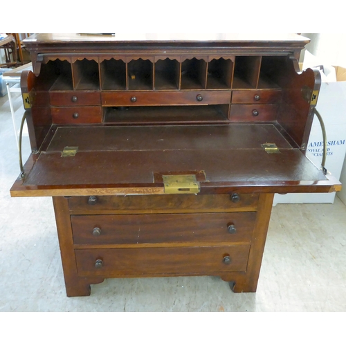 303 - A late 19thC mahogany secretaire chest with a facsimile fall front over five long drawers, raised on... 