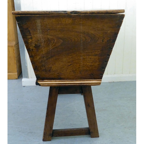 319 - A late 18th/early 19thC elm dough bin with angled sides and a removeable lid, raised on square legs ... 