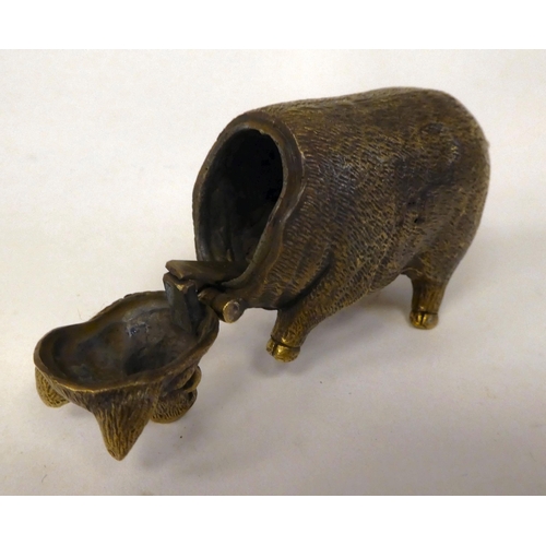 32 - A brass novelty vesta case, fashioned as a pig with a hinged cap