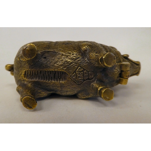 32 - A brass novelty vesta case, fashioned as a pig with a hinged cap