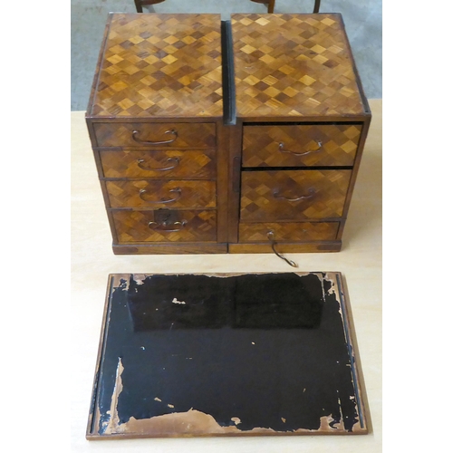 322 - A mid 20thC Japanese parquetry fruitwood veneered table top collector's chest with seven drawers, on... 