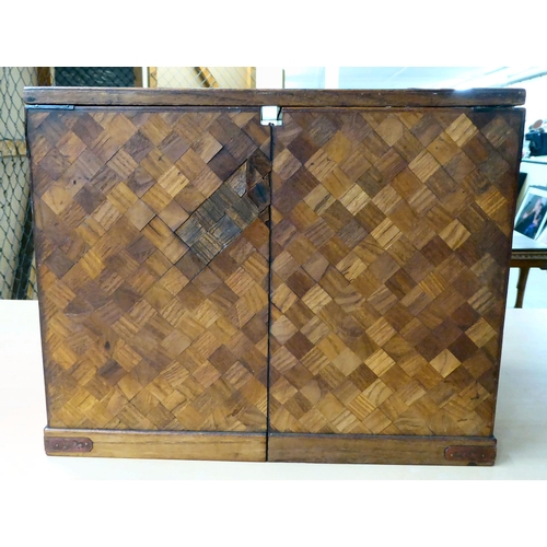 322 - A mid 20thC Japanese parquetry fruitwood veneered table top collector's chest with seven drawers, on... 