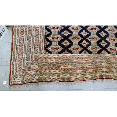 325 - A Bokhara carpet, decorated with geometric patterns, on a cream ground  88