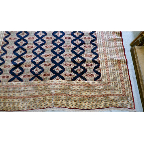 325 - A Bokhara carpet, decorated with geometric patterns, on a cream ground  88