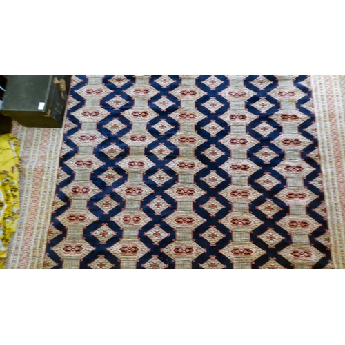 325 - A Bokhara carpet, decorated with geometric patterns, on a cream ground  88