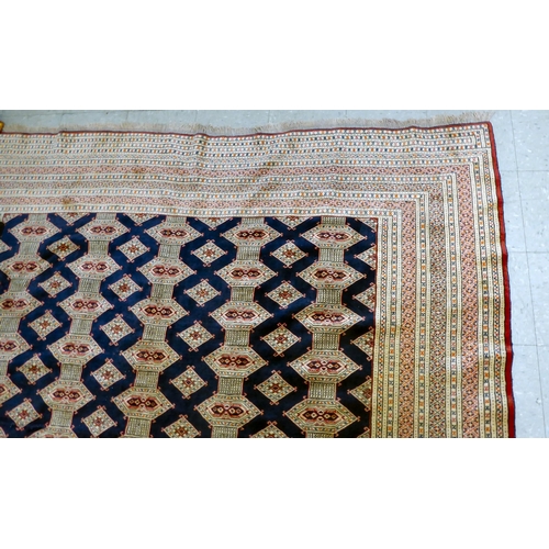 325 - A Bokhara carpet, decorated with geometric patterns, on a cream ground  88