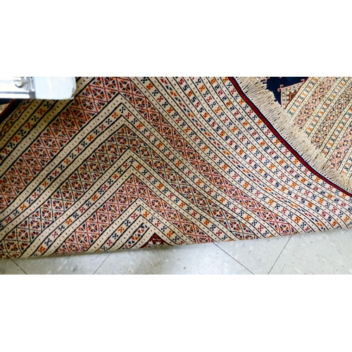 325 - A Bokhara carpet, decorated with geometric patterns, on a cream ground  88