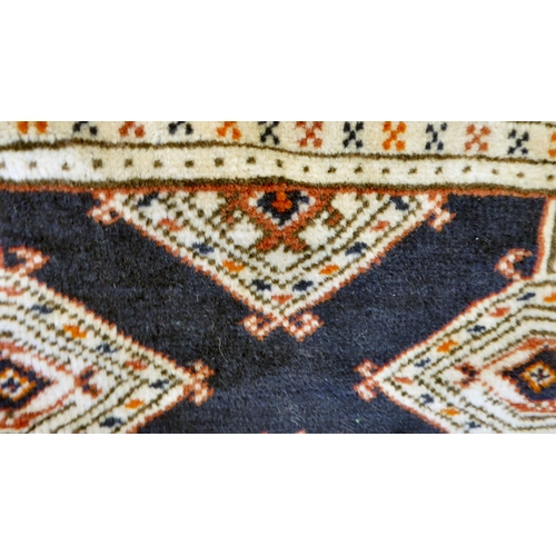 325 - A Bokhara carpet, decorated with geometric patterns, on a cream ground  88