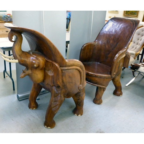 326 - A pair of modern novelty one-piece carved teak enclosed armchairs, fashioned as trumpeting elephants... 