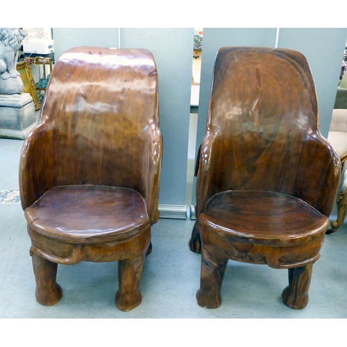 326 - A pair of modern novelty one-piece carved teak enclosed armchairs, fashioned as trumpeting elephants... 