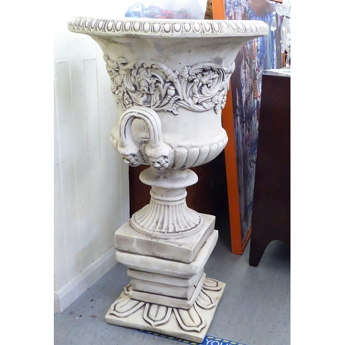 332 - A cream painted composition stone pedestal, twin handled urn, on a separate plinth  43