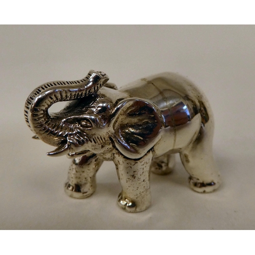 56 - A Sterling silver miniature standing, trumpeting model elephant