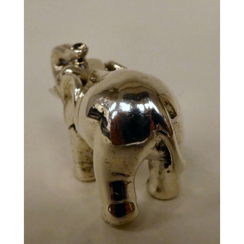 56 - A Sterling silver miniature standing, trumpeting model elephant