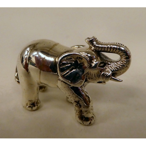 56 - A Sterling silver miniature standing, trumpeting model elephant