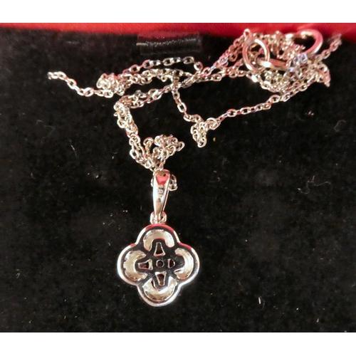 66 - A platinum set, ruby and diamond, four leaf clover pendant, on a fine neckchain