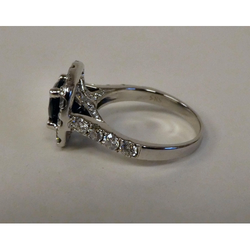 73 - An 18ct white gold, claw set sapphire and diamond ring  approx. 4ct