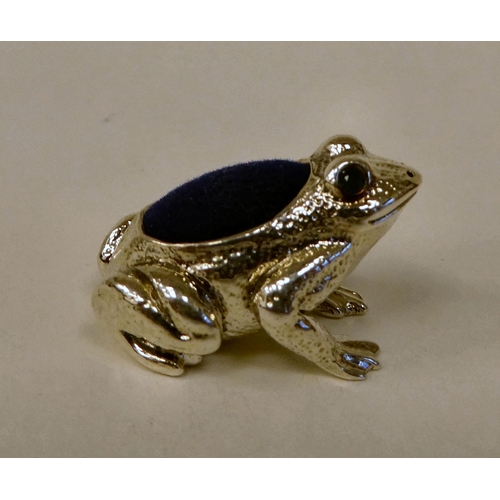 79 - A Sterling silver novelty frog pin cushion with glass eyes