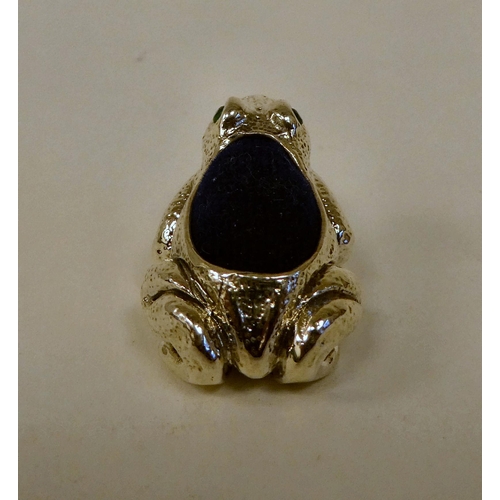 79 - A Sterling silver novelty frog pin cushion with glass eyes