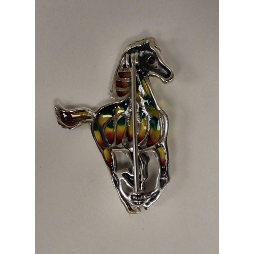 87 - A white metal and plique a jour horse brooch