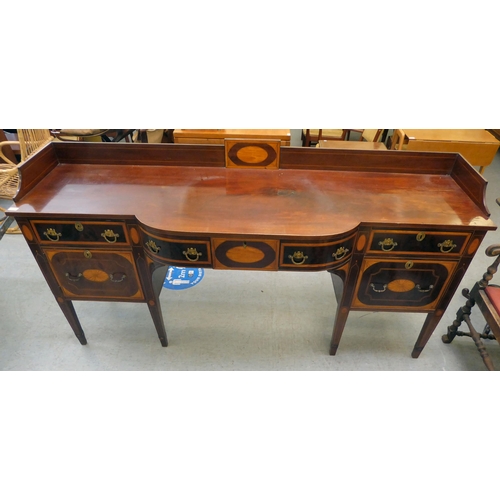 90 - A Regency Irish satinwood inlaid, mahogany breakfront sideboard with three inline drawers, above a c... 