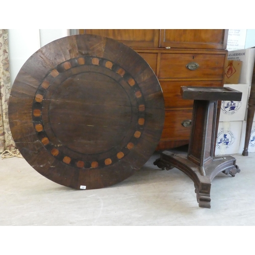 152 - A Victorian oak breakfast table with a decoratively inlaid centre, raised on a triform pillar, an in... 