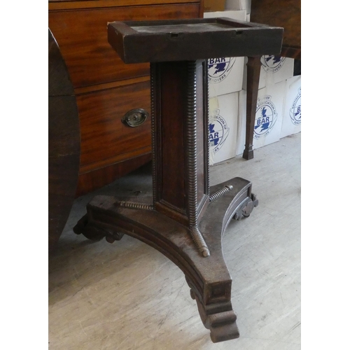 152 - A Victorian oak breakfast table with a decoratively inlaid centre, raised on a triform pillar, an in... 