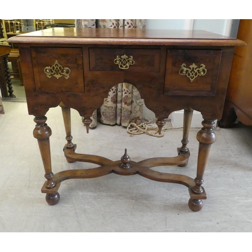 159 - A 17thC style yew wood lowboy, comprising three short drawers, over a fretwork and pendant frieze, r... 