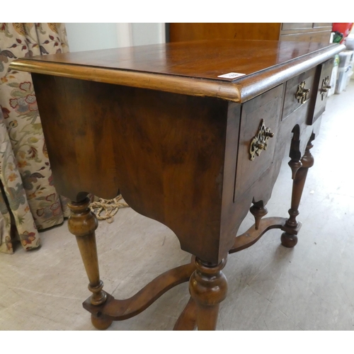 159 - A 17thC style yew wood lowboy, comprising three short drawers, over a fretwork and pendant frieze, r... 