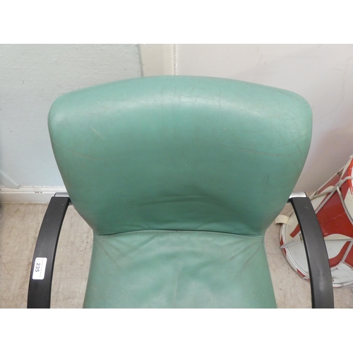 235 - A modern Verco desk chair with a cushioned green hide upholstered seat, on a splayed frame